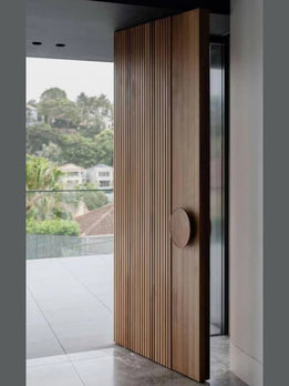 Architectural Statement Fluted Timber Pivot Door Featuring Minimalist Circular Grip