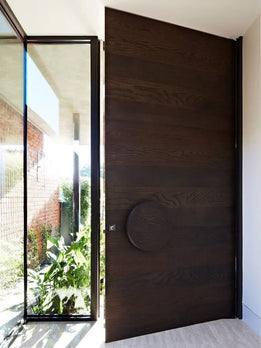 Modern Dark Oak Pivot Door with Horizontal Grain and Round Handle