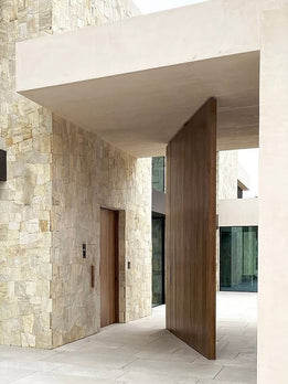 Contemporary Natural Wood Pivot Entry Door with Sleek Integrated Black Pull