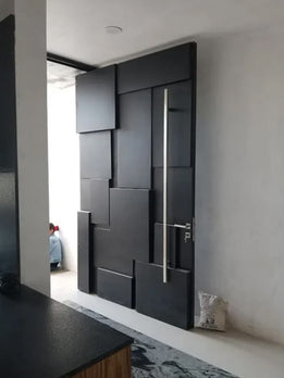 Architectural Statement Dark Gray Pivot Door Featuring Sculpted Block Facade