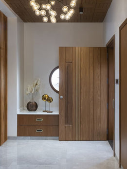 Architectural Wooden Pivot Door With Sleek Gold Metal Inlay Details